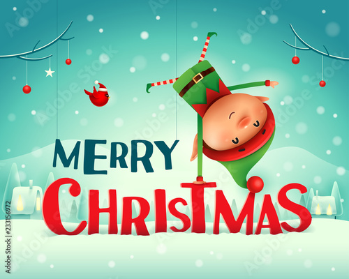 Merry Christmas! Little elf standing on his arm in Christmas snow scene winter landscape.