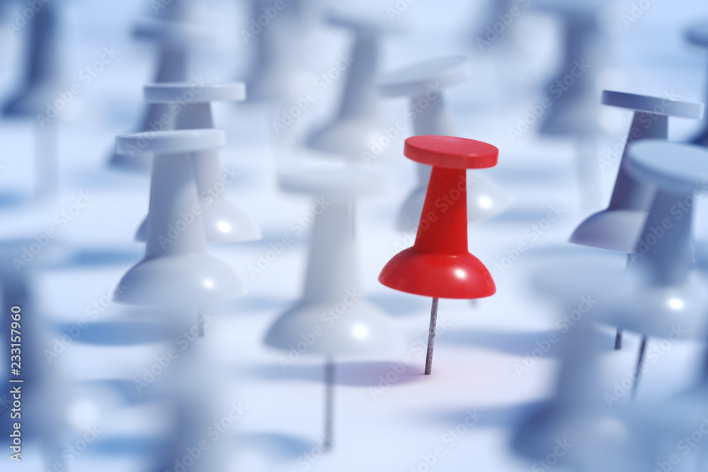 Difference concept. Red pushpin or thumbtack and many white ones Difference concept. Red pushpin or thumbtack and many white ones