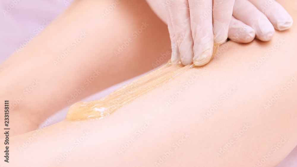 Naklejka premium Depilation spa procedure. Woman hair remove waxing. Epilation sugaring. Legs foot