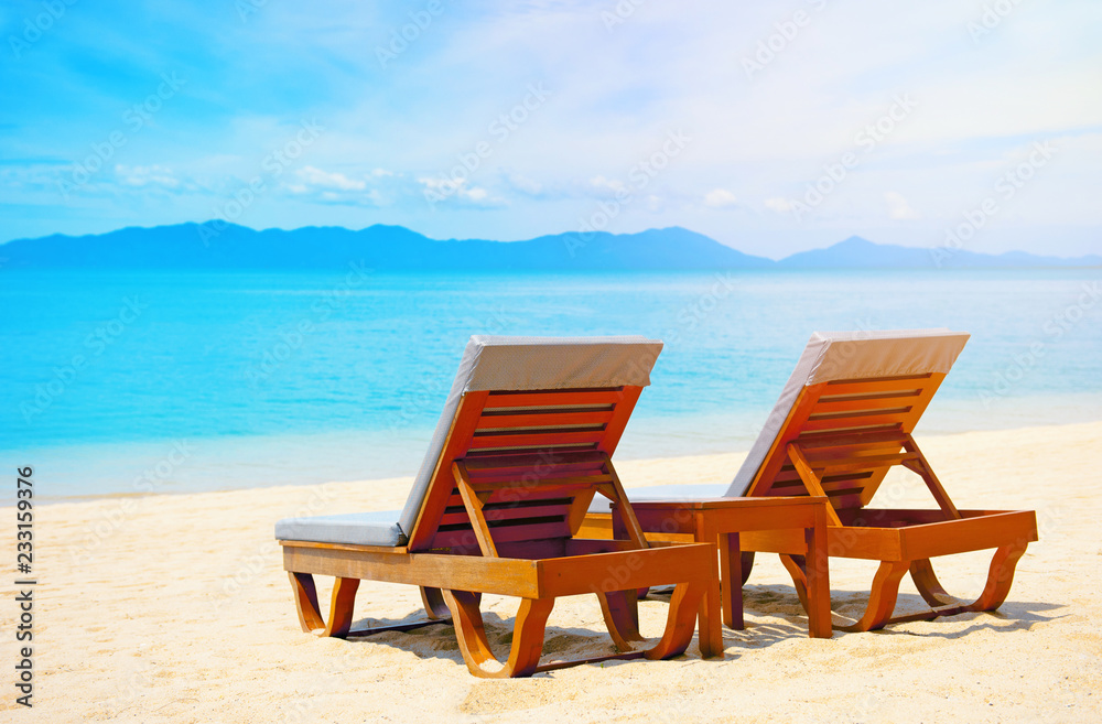 Beautiful beach. Chairs on the  sandy beach near the sea. Summer holiday and vacation concept.