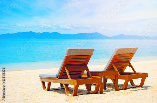 Beautiful beach. Chairs on the sandy beach near the sea. Summer holiday and vacation concept. © Andrii Vergeles