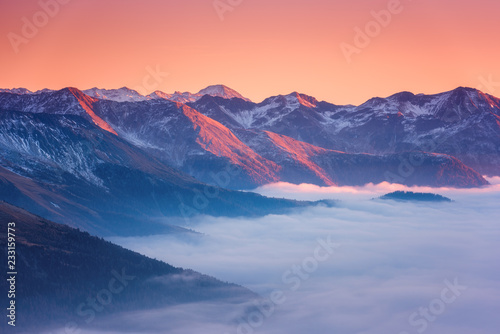 Amazing sunset in Alps mountains over cloud and mountain ridge in sunlight  Hohe Tauern national park  Carinthia  Austria