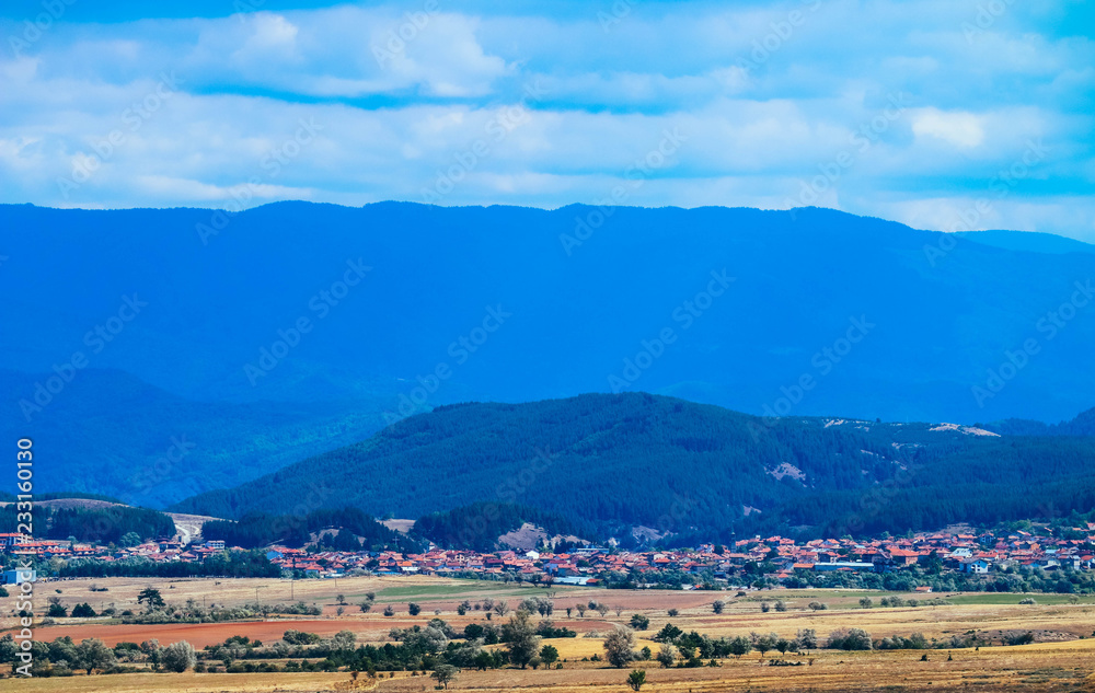 Photo depicting a beautiful colorful Bulgarian mountain village landscape, summertime. Europe, Bulgaria, rural village.