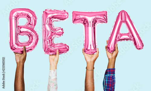 Hands holding beta word in balloon letters