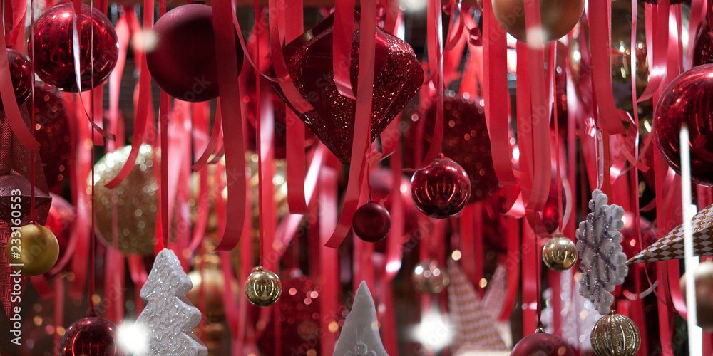 Fototapeta premium festive new year or christmas decoration of space with bright red ribbons and toys