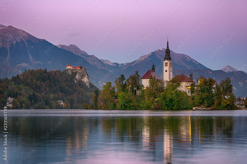 Beautiful sunrise landscape of famous mountain lake Bled in Slovenia with church on small green island