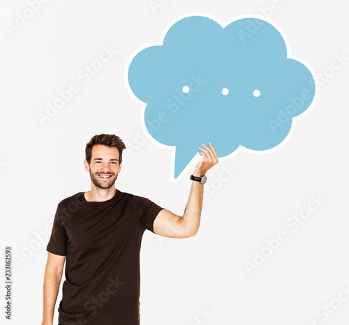 Cheerful man holding a blank speech bubble symbol