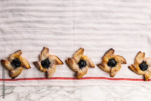 Scandinavian pastry Joulutorttu is traditional finnish and Swedish christmas pastry. It is traditionally made from puff pastry in the shape of a star or pinwheel and filled with prune jam and often du photo