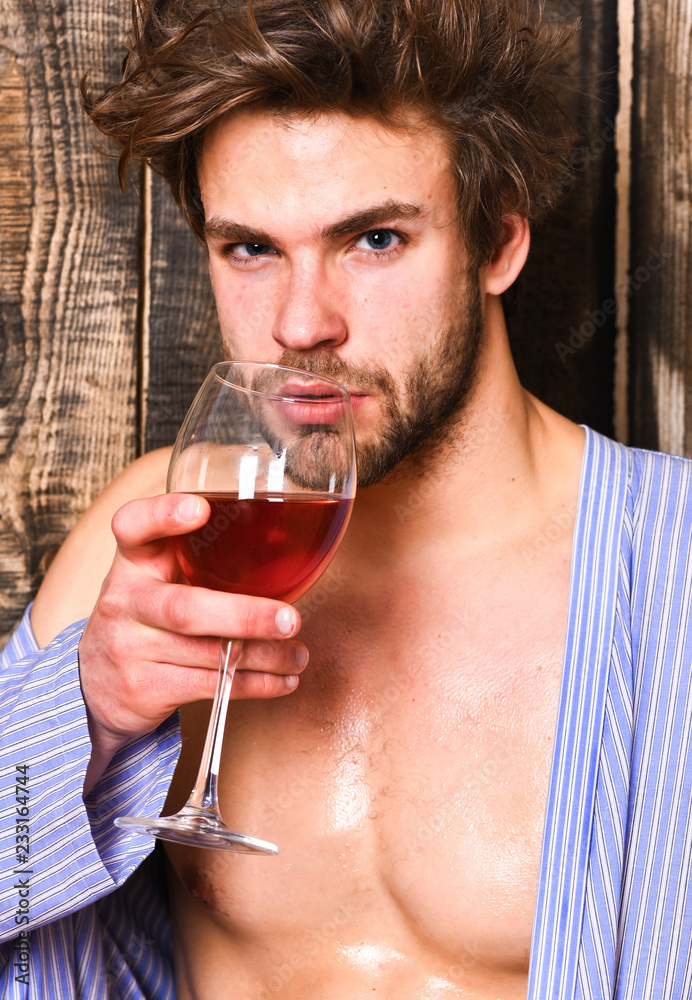 Drink wine and relax. Guy attractive relaxing with alcohol drink. Man sexy  chest wet skin after bath hold wineglass. Bachelor enjoy wine after bath.  Macho tousled hair degustate luxury wine Stock Photo |