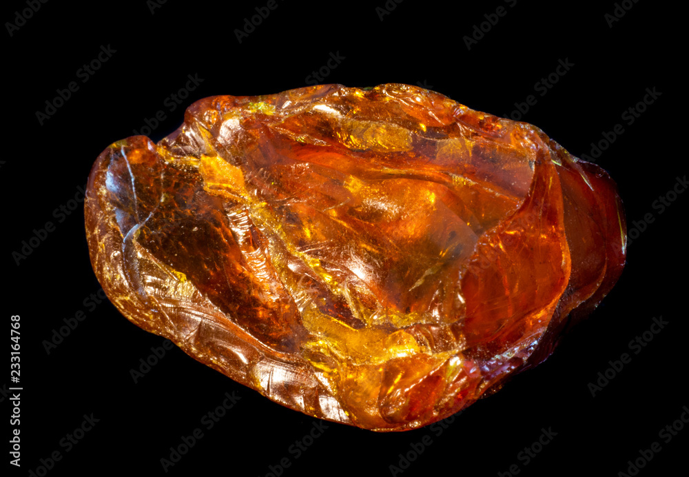 Natural piece of amber on a black background Natural piece of amber on a black background
