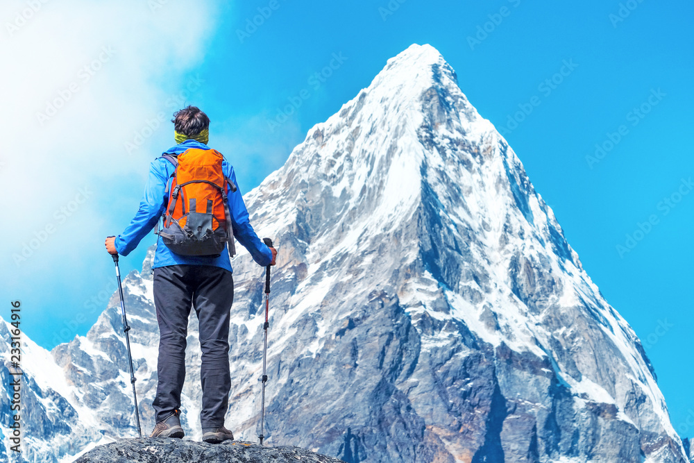 Hiker with backpacks reaches the summit of mountain peak. Success, freedom and happiness, achievement in mountains. Active sport concept. Hiker with backpacks reaches the summit of mountain peak. Success, freedom and happiness, achievement in mountains. Active sport concept.