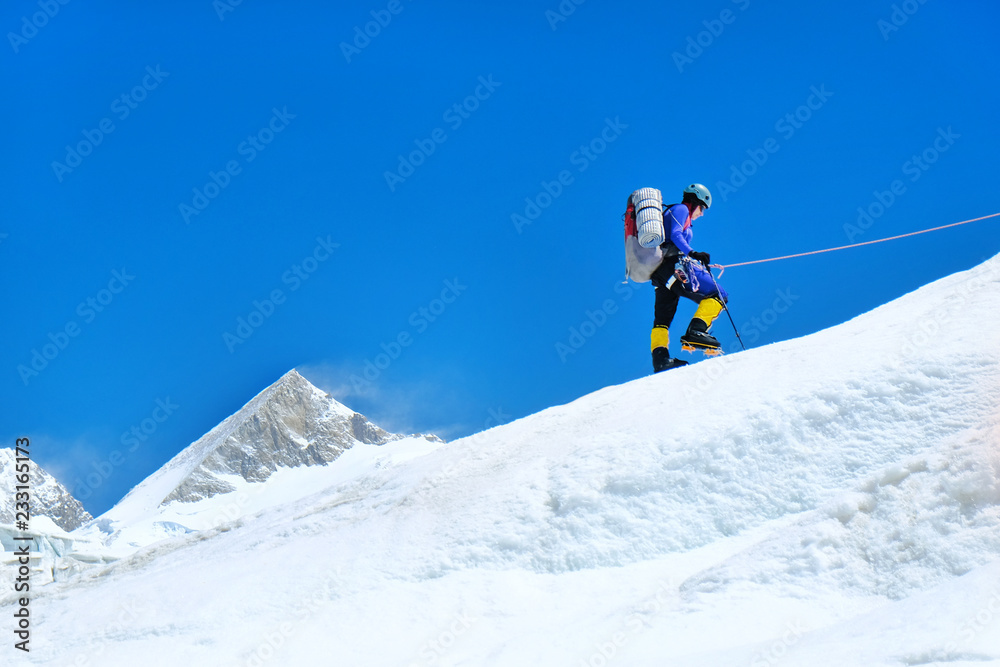 Climber reaches the summit of mountain peak. Climber on the glacier. Success, freedom and happiness, achievement in mountains.