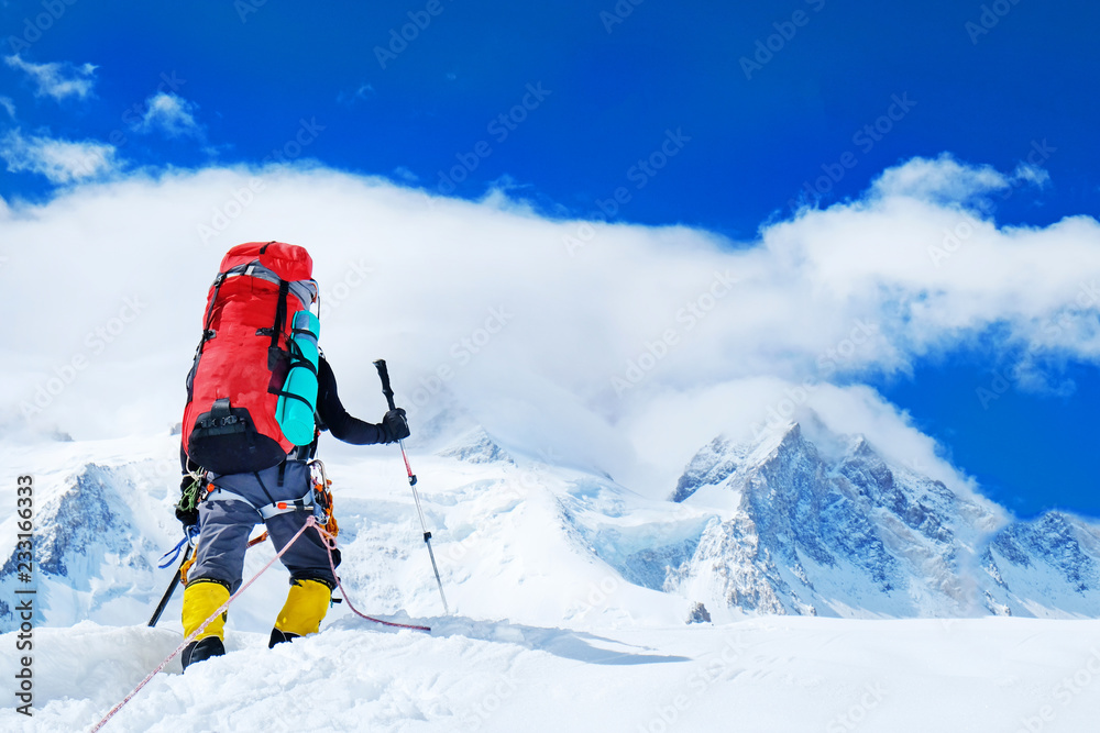 Group of climbers with backpacks reaches the summit of mountain peak. Success, freedom and happiness, achievement in mountains. Active sport concept.