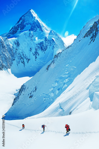 Foto Group of climbers reaches the summit of mountain peak