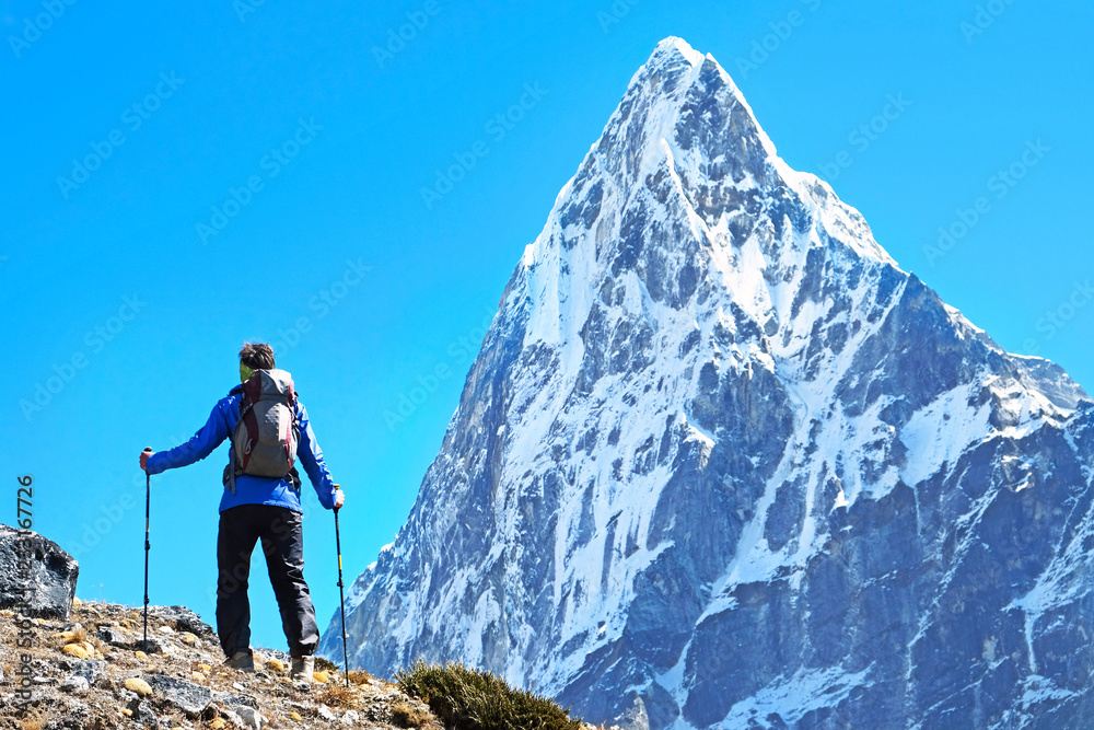 Fototapeta premium Hiker with backpacks reaches the summit of mountain peak. Success, freedom and happiness, achievement in mountains. Active sport concept.