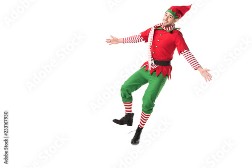 cheerful man in christmas elf costume jumping isolated on white background photo