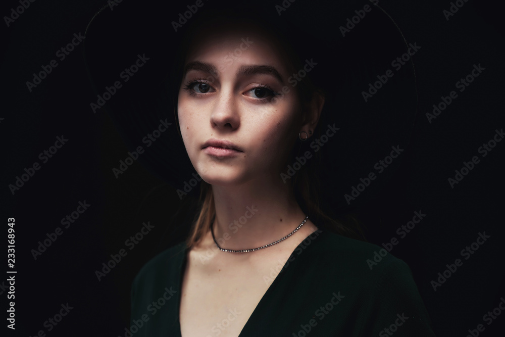 Beautiful, young girl in a stylish felt hat with wide brim sad and nostalgic Beautiful, young girl in a stylish felt hat with wide brim sad and nostalgic