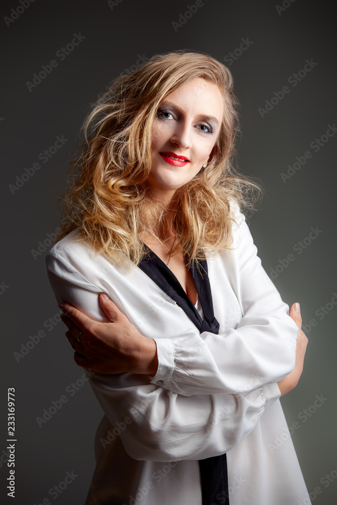 Woman portrait with perfect blonde hair. Over grey background. Woman portrait with perfect blonde hair. Over grey background.