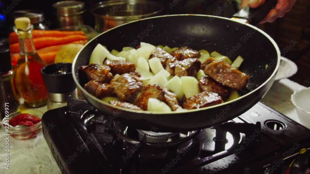 Preparing Irish stew: beef, potatoes, carrots and herbs. Slow motion Preparing Irish stew: beef, potatoes, carrots and herbs. Slow motion