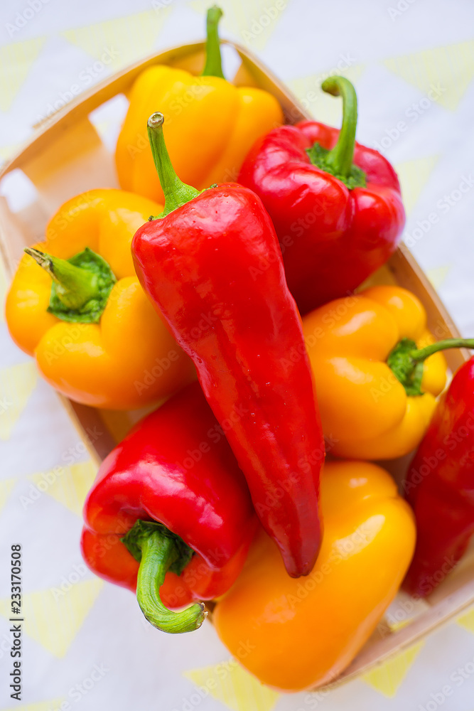 yellow and red peppers closeup on colorful napkin. yellow and red peppers closeup on colorful napkin.