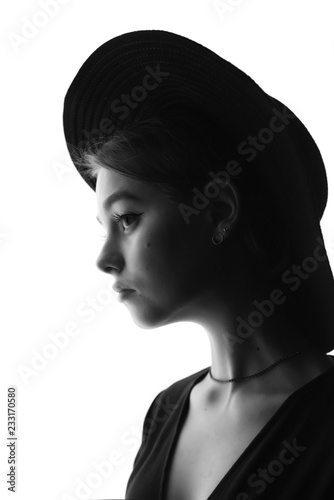 Beautiful, young girl in a stylish felt hat with wide brim sad and nostalgic