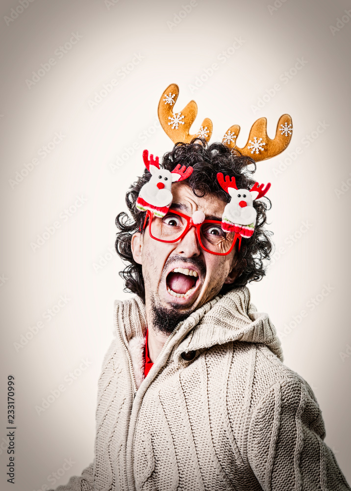 Man with christmas glasses and dreadful face