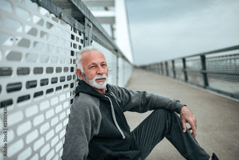 Portrait of senior athlete in the city environment, looking at camera. Portrait of senior athlete in the city environment, looking at camera.