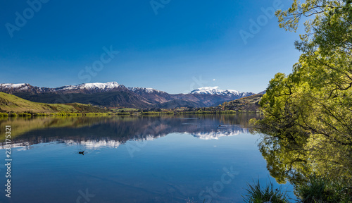 Lake Hayes reflecting Coronet  mountains  near Queenstown  New Zealand