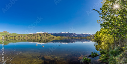 Lake Hayes reflecting Coronet mountains, near Queenstown, New Zealand