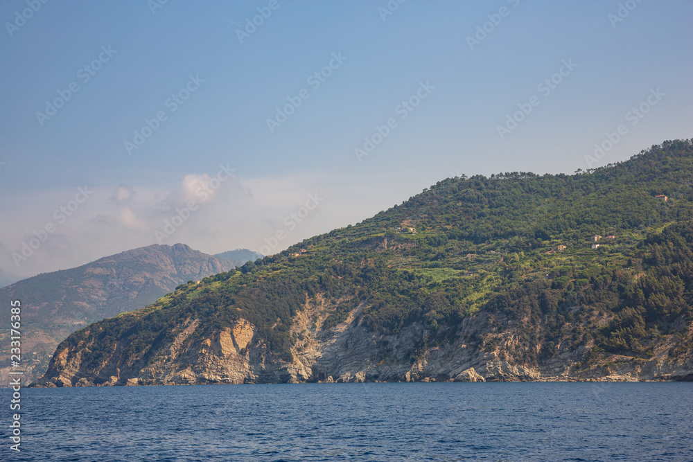 The rugged coastline of the Ligurian coast, with several houses perched on top of the cliffs outside Monterosso al Mare, Italy