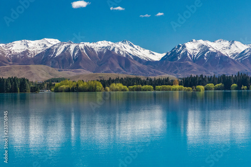 Lake Ruataniwha  New Zealand  South Island  trees and mountains  azure water reflections