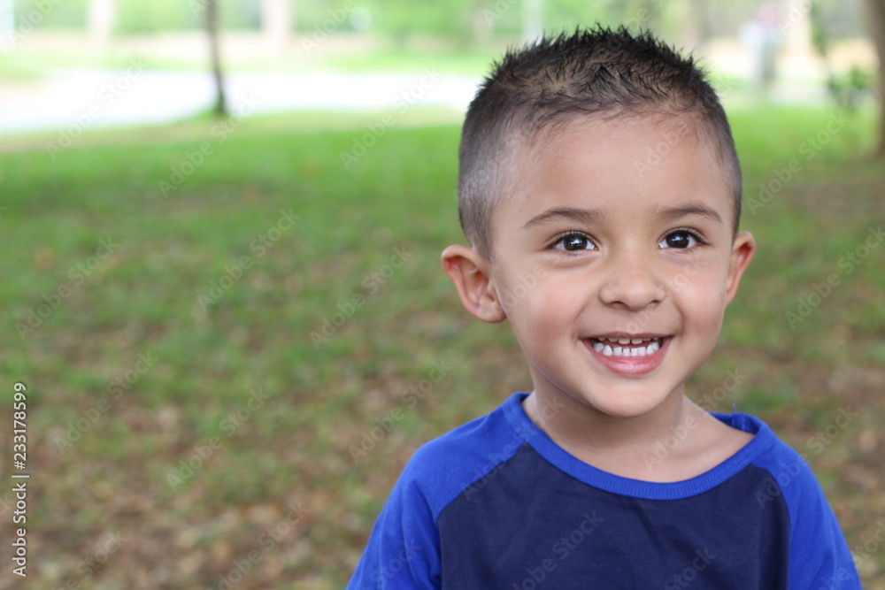 Hispanic child smiling in the park Hispanic child smiling in the park
