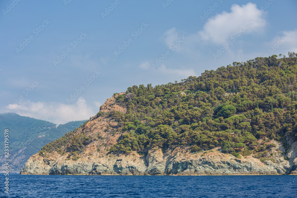 Boating and kayaking under the dramatic cliffs of the Ligurian coastline, just outside of Moneglia, Italy