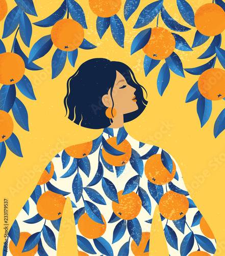 Beautiful girl in a dress with oranges pattern print and a orange tree background.