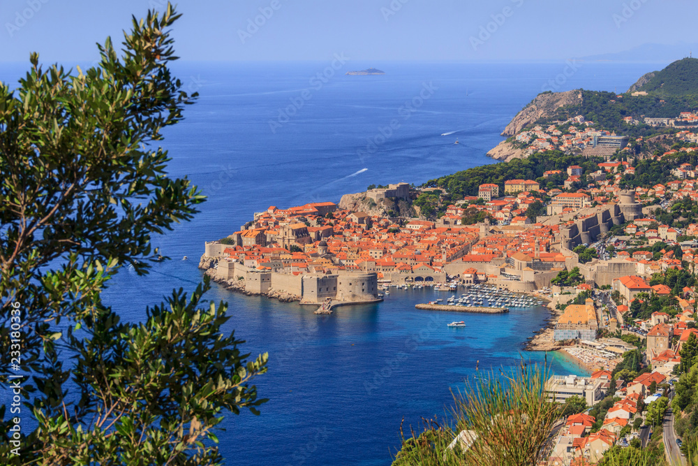 Dubrovnik old town surrounded by fortified walls above the Adriatic sea, Croatia. Picturesque view on the old town (medieval Ragusa) and Dalmatian Coast of Adriatic Sea.