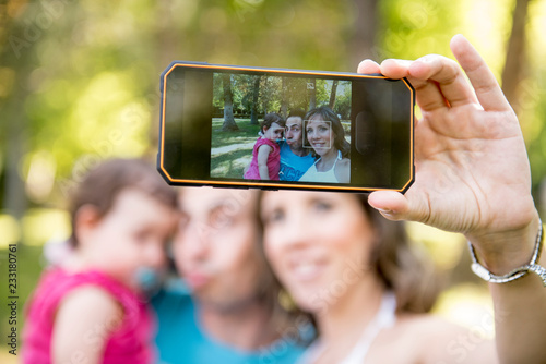 Parents taking a selfie with their baby