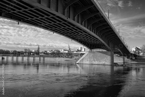 Warsaw - a bridge over the Vistula river with a panorama of the coastal city - photo in black and white