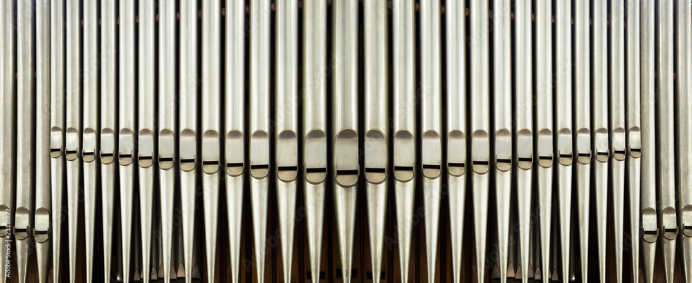 part of the church organ with many air pipes made of metal