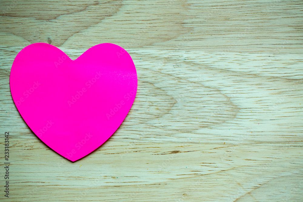 Pink stick note isolated on wood background.paper heart shape on wood texture with copy space. Image for Valentines day.symbol of love. use to greeting card and background.horizontal. Pink stick note isolated on wood background.paper heart shape on wood texture with copy space. Image for Valentines day.symbol of love. use to greeting card and background.horizontal.