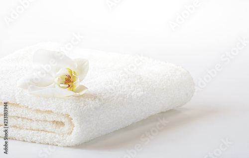 White Spa towel with Orchid flower on white background