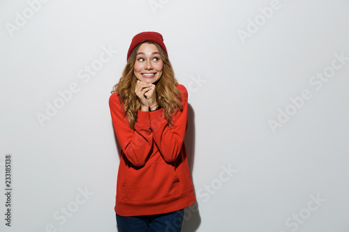 Excited young woman posing isolated over grey wall background.