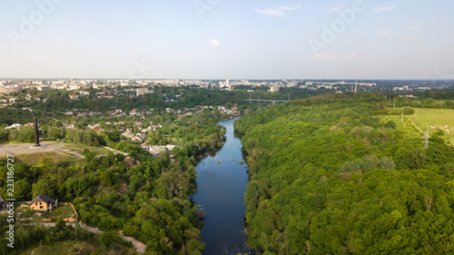 Aerial view of a river with trees and houses on the shore