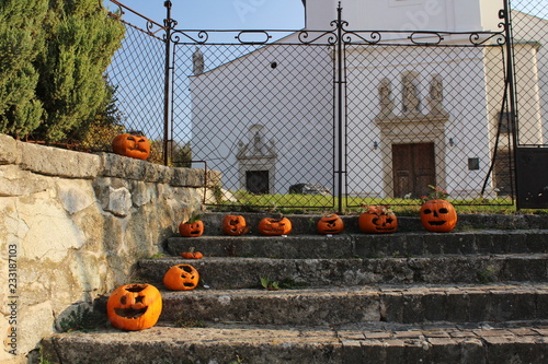 Halloween decorations made of pumpkins in front of a church © Vladimra
