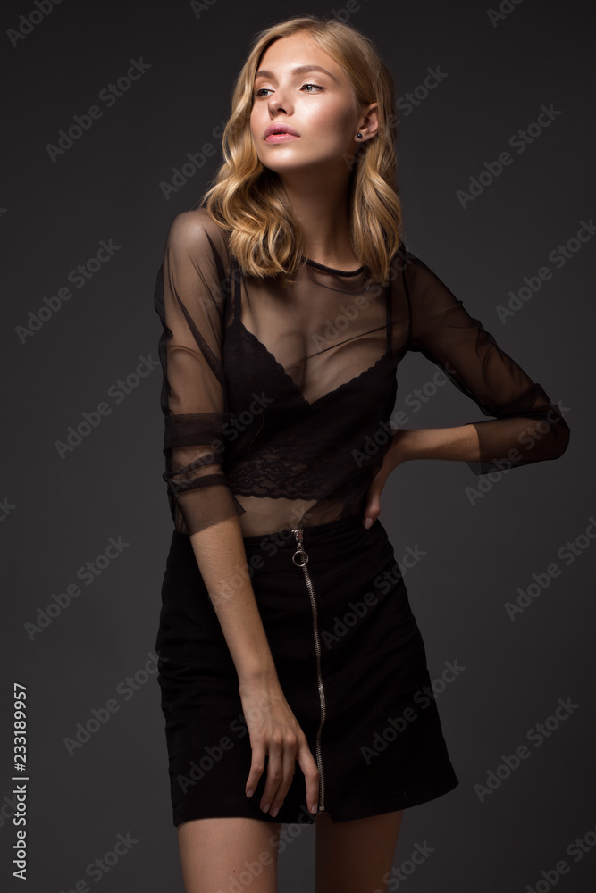fashion model with long hair, beautiful eyes, perfect skin is posing in studio for glamour test photo shoot showing different poses. Picture taken in the studio on a gray background. fashion model with long hair, beautiful eyes, perfect skin is posing in studio for glamour test photo shoot showing different poses. Picture taken in the studio on a gray background.