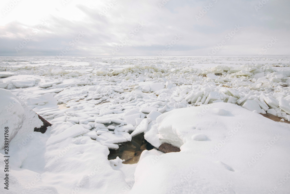 Frozen rocky beach  covered in snow