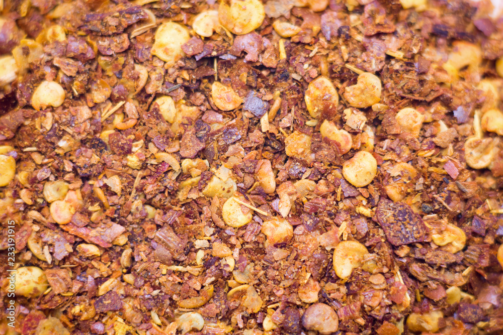 Dried chili flakes and seeds isolated on white background.Pile crushed red cayenne pepper,top view. Dried chili flakes and seeds isolated on white background.Pile crushed red cayenne pepper,top view.