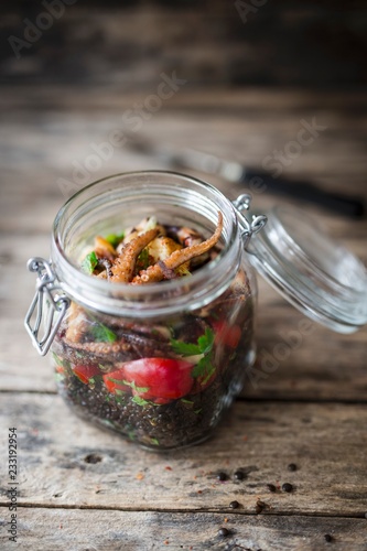 Lentil salad with octopus in a glass jar photo