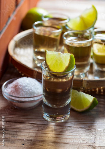 Tequila and lime slices.