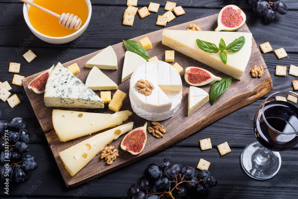 Cheeseboard with cheese brie , parmesan , camembert and dorblu . Food on wooden board Cheeseboard with cheese brie , parmesan , camembert and dorblu . Food on wooden board