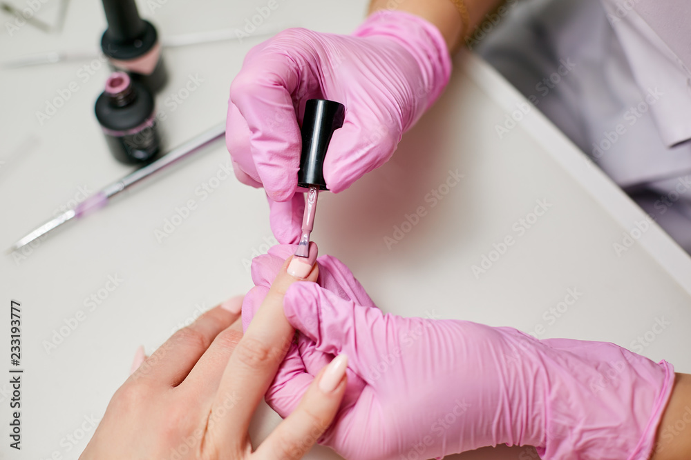 The master uses nail polish. Apply pink nail polish on the nails The master uses nail polish. Apply pink nail polish on the nails